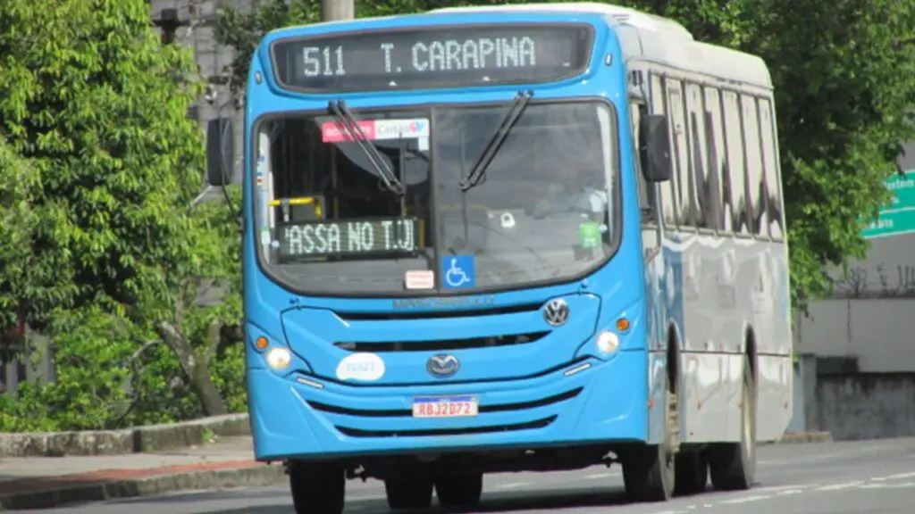 Carnaval 2023: linhas de ônibus com programação especial para toda Grande Vitória Ônibus azul do sistema Transcol, transitando em uma rua arborizada com o letreiro marcando Terminal Carapina