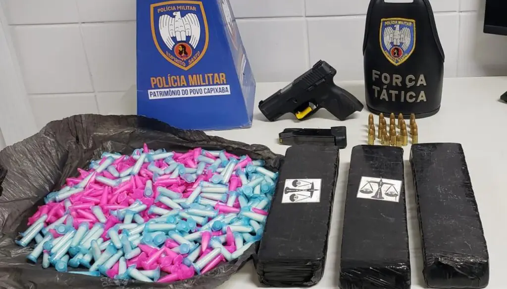 Força Tática quebra a banca e prende traficante armado com drogas na Serra Sobre uma mesa branca uma caixa com propaganda da PMES, uma Pistola G2C, calibre 9mm, carregada com 12 munições, além de um carregador reserva contendo mais 10 munições e a quantia de R$30,00 em espécie388 pinos de cocaína e três tabletes de maconha.