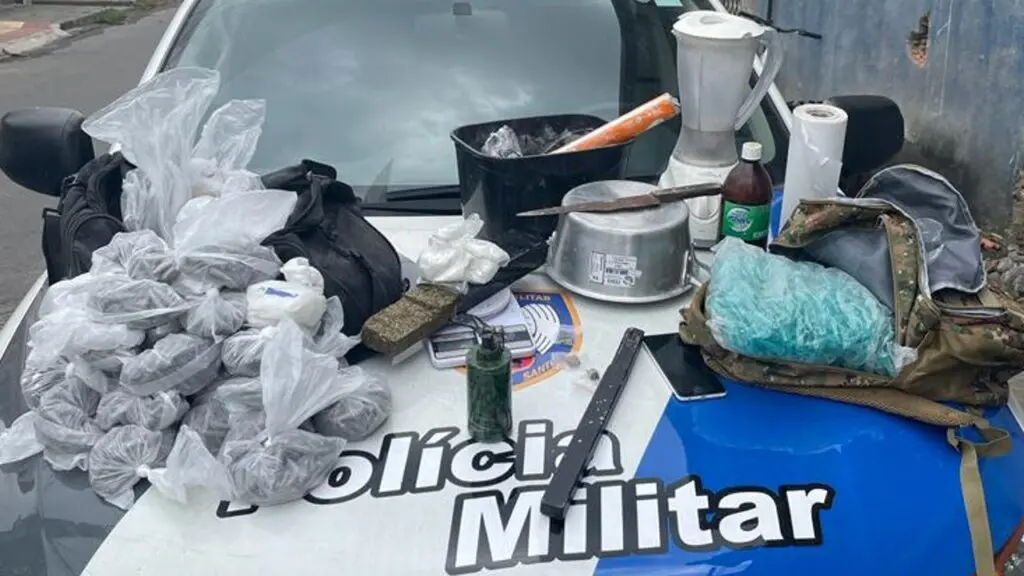 Polícia Militar detona laboratório do tráfico após denúncias anônimas na Serra Sobre o capo de uma viatura da PM, 3420 pinos de cocaína, uma sacola com aproximadamente 1,130 kg de cocaína, 46 buchas de maconha, 182 pedras de crack, um tablete de maconha de 790g, um simulacro de granada, uma balança de precisão, além de um celular e material para o corte e embalagem das drogas.