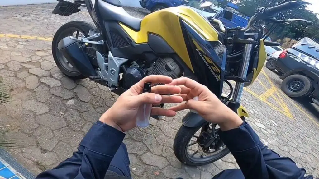 Vídeo: motocicleta roubada em SP é recuperada pela Guarda da Serra em Vila Nova de Colares Foto com imagem de um agente ao lado de uma motocicleta Honda CB 300 F Twister, no patio da 3ª Delegacia Regional da Serra