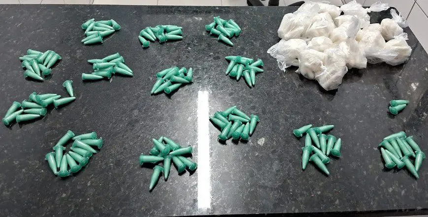 Sobre uma mesa de mármore 272 pinos de cocaína, além de matérias para a embalagem