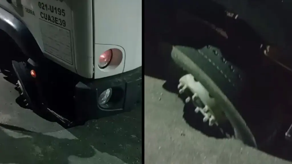 Caminhão afundando dentro de buraco no asfalto no bairro Novo Horizonte.