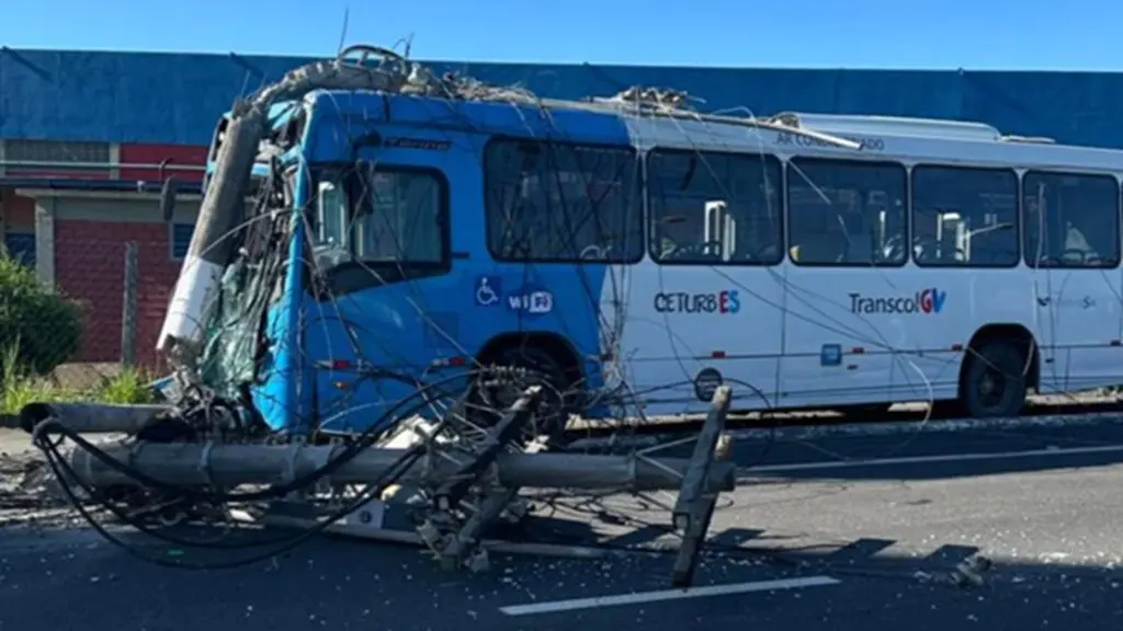 Ônibus do Transcol acidentado na Avenida Talma Rodrigues, na Serra, com poste derrubado e fios espalhados na via.