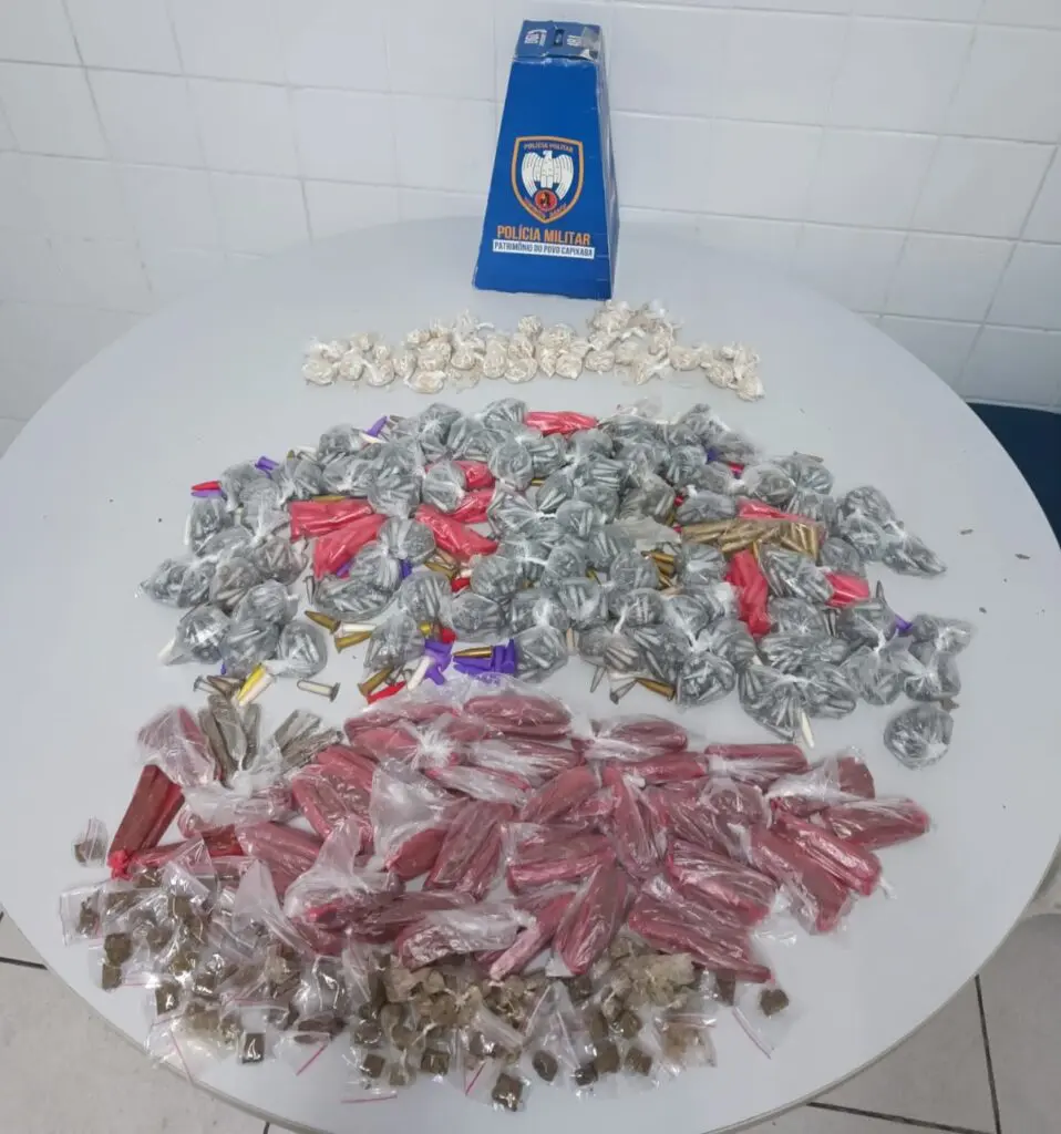 Imagem de apreensões de drogas, sobre uma mesa 1.040 pedras de crack, 269 buchas de maconha e 2.410 pinos de cocaína.