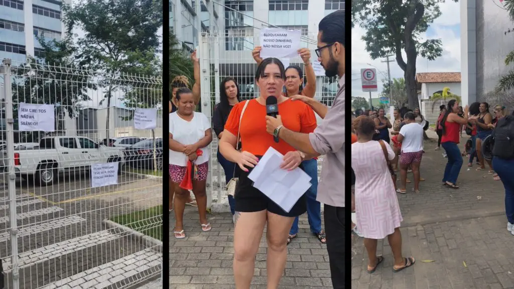 Grupo de trabalhadoras terceirizadas segurando cartazes em protesto na entrada da Prefeitura da Serra.