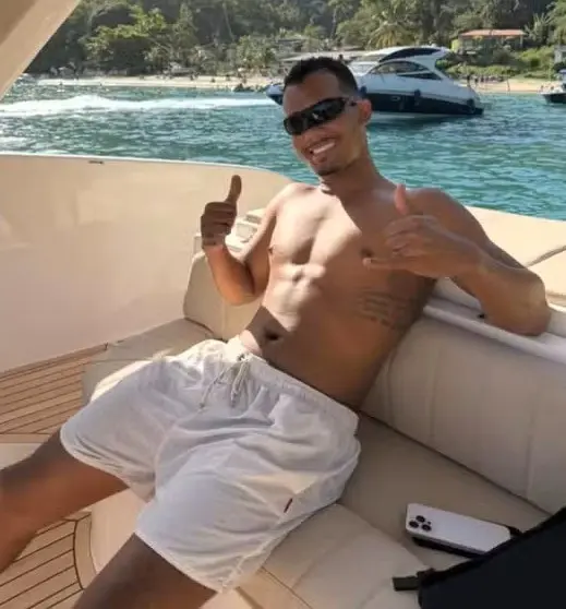 Foto de um homem (Flavio dos Santos Medina) usando oculos escuros dentro de uma lancha, posando para uma foto.