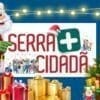 Papai Noel apontando para Banner de propaganda Serra mais cidadã edição Natal