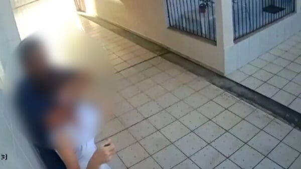 Imagens de videomonitoramento da casa da vítima, que mostra o homem enforcando (mata leão) a vítima em seu quintal