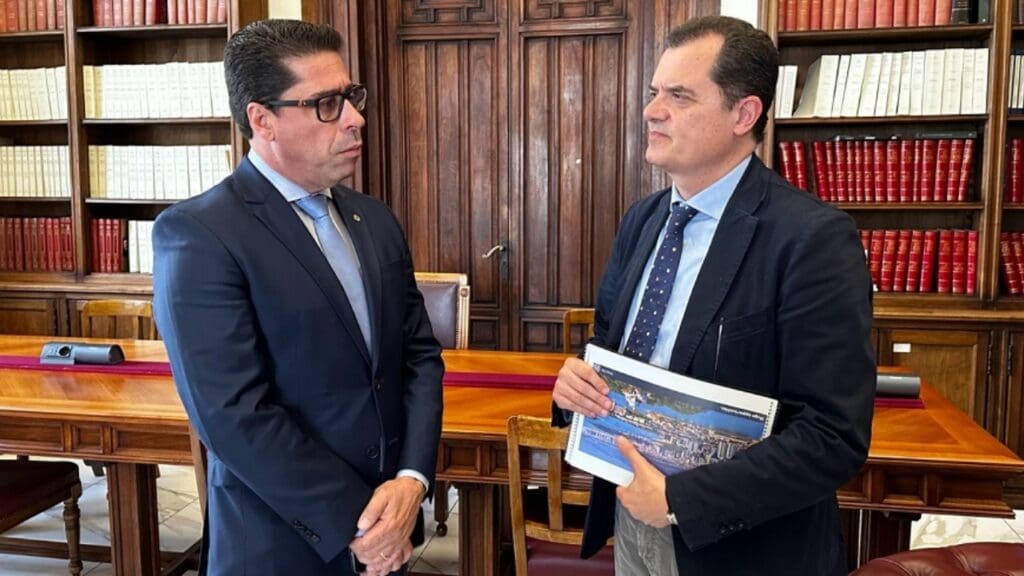 Fábio Porta segurando cartão postal do ES e Marcelo Santos presente em foto