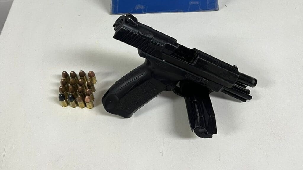 Sobre uma mesa branca uma pistola calibre 9mm, com a numeração raspada, carregada com 16 munições do mesmo calibre