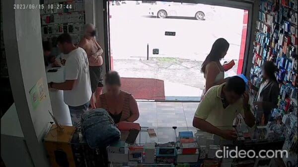 Imagem de uma camera de segurança de uma loja de celulares 6 pessoas dentro da loja